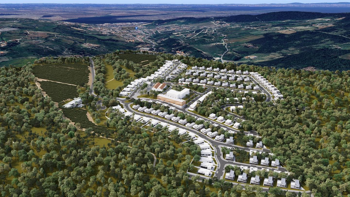 Aerial render of the Quinta dos Carvalhos masterplan — 392 homes arranged along curved streets across the 53-hectare estate